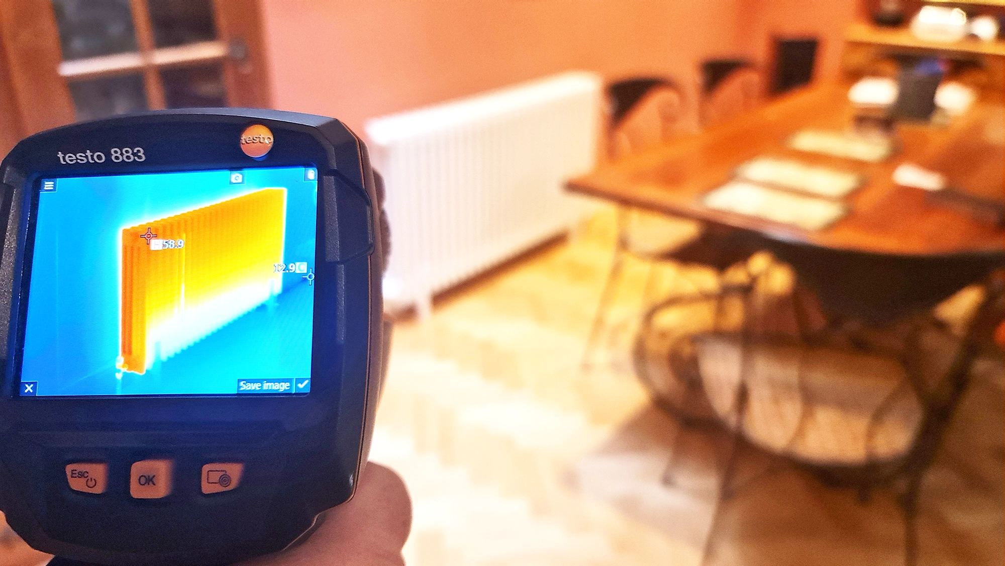 Image of a Testo 883 thermal imaging camera checking the heat distribution on a radiator after a powerflush service in a Central London home.